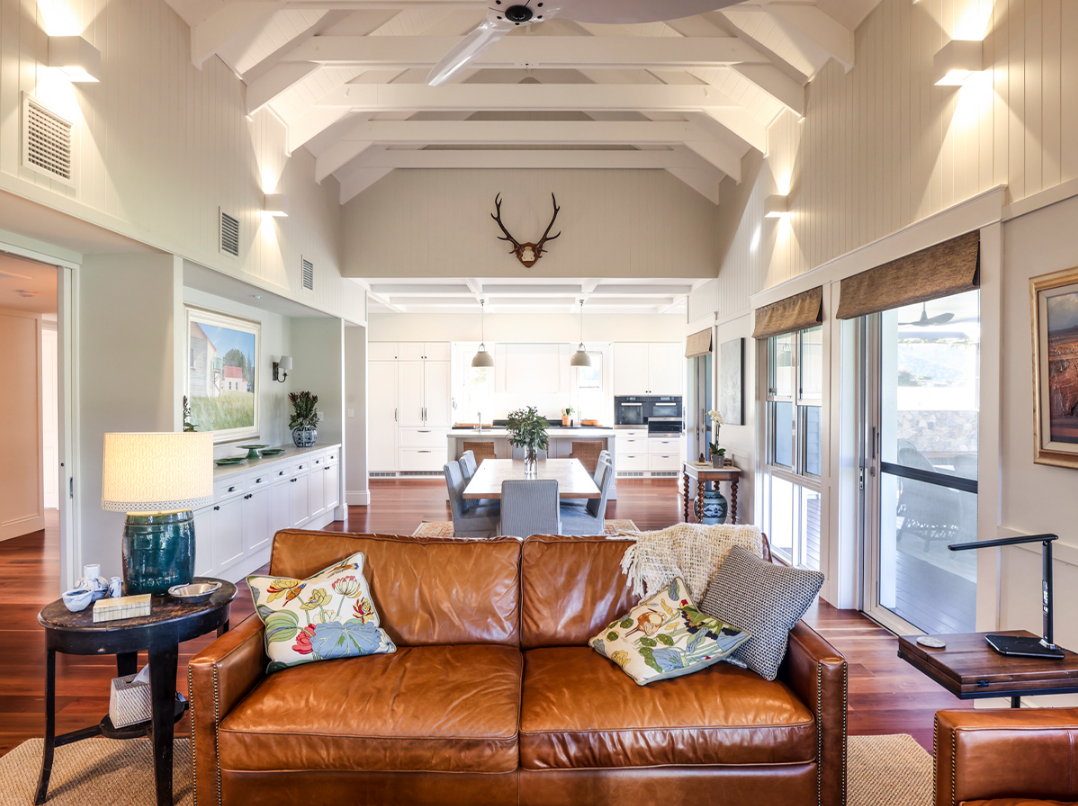 Hamptons-style open-plan living and dining area designed for multigenerational living, with vaulted ceilings, natural light, and timeless detailing.